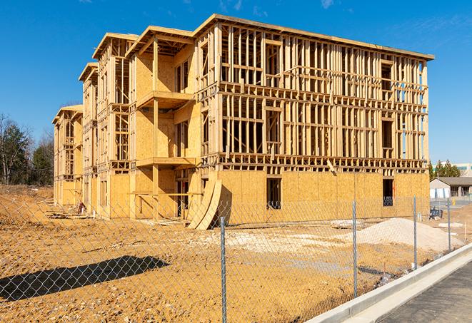 a temporary chain link fence in front of a building under construction, ensuring public safety in Neenah